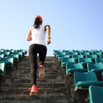 Runner athlete running on stairs. woman fitness jogging workout wellness concept.