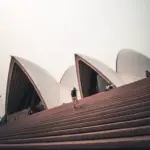 A man running up the steps to the Sydney Opera House