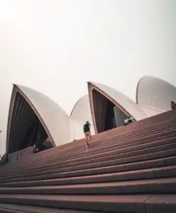 A man running up the steps to the Sydney Opera House