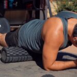 a man using a foam roller on his legs