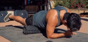 a man using a foam roller on his legs